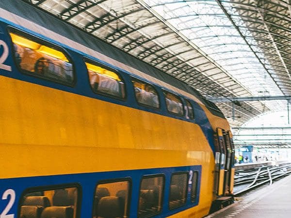 Train departing from Amsterdam Centraal en route to Schiphol Airport. Read how to get to Schiphol Airport from Amsterdam City! #travel #amsterdam #schiphol