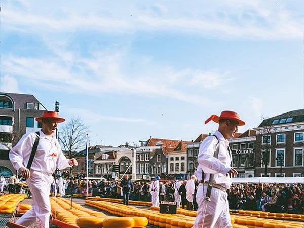 Two cheese carriers carrying cheese within the Alkmaar Cheese Market in Holland!