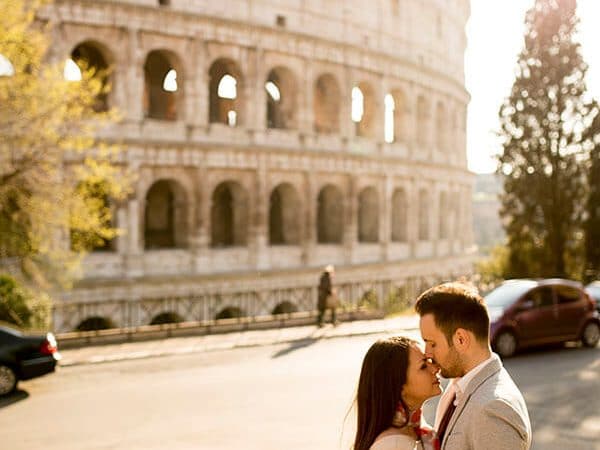 Newly married couple outside of the Roman Coliseum in Rome, Italy enjoying their honeymoon in Italy!
