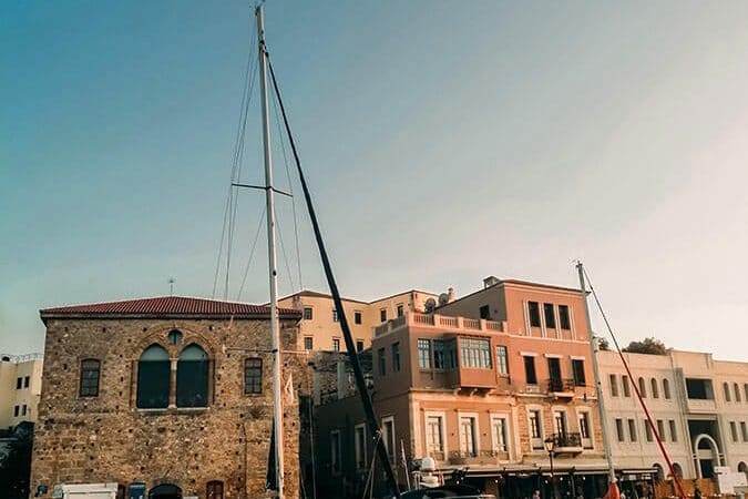 Beautiful golden hour with ships near port of Chania, Crete. One of the highlights of any Crete itinerary!